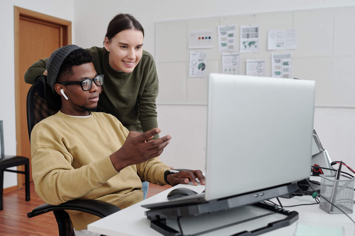 Two programmers in the office are talking about AI